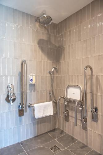 a bathroom with a shower with a white towel at Oyster House in The Mumbles