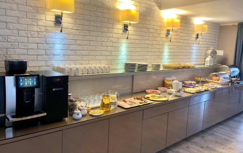 a buffet line in a restaurant with food on it at Hotel Krystyna in Szczytno