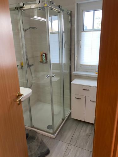 グロヴェにあるSchönes Appartment mit Fernblickのシャワーと洗面台付きのバスルーム
