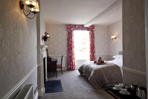 a bedroom with a bed and a window at Trelough House B&B in Wormbridge