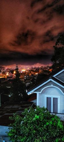 a view of a city at night with a building at Ha Khoa Hotel Dalat in Da Lat