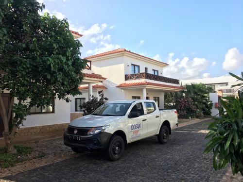 a white truck parked in front of a house at Tortuga Beach Villa in Santa Maria