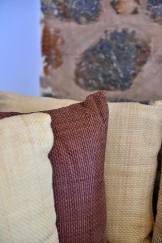 a couch with two pillows on top of it at Hotel Sophia in Hydra