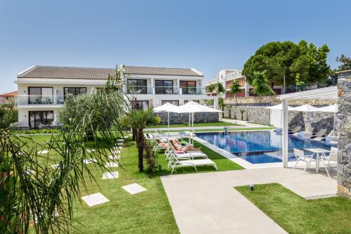 a villa with a swimming pool and a resort at Epicentrum Suites Fresh in Limenaria