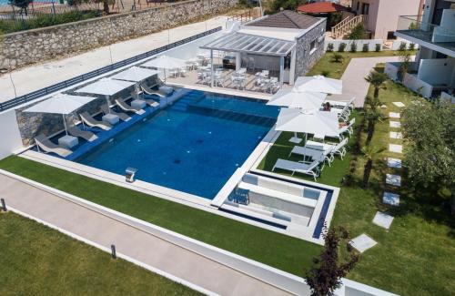 an overhead view of a swimming pool with umbrellas at Epicentrum Suites Fresh in Limenaria