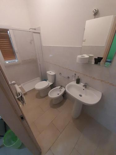 a bathroom with a sink and a toilet and a mirror at CTA Catania Aeroporto fontanarossa reception h24 in Catania