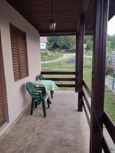 a patio with a table and chairs on a porch at Nikolija in Žabljak