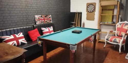 a living room with a pool table and a couch at Maison familiale Jardin parking, 10 min plage, 1* in Saint-Cyr-sur-Mer