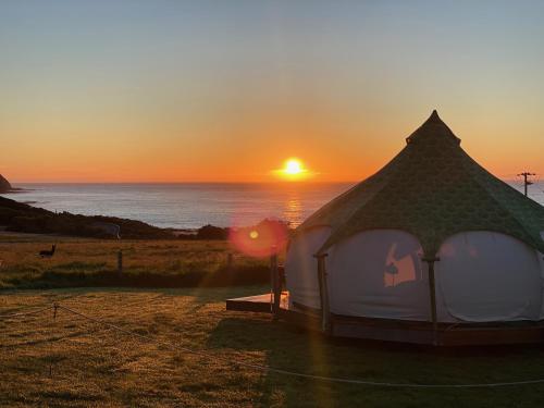 a white gazebo with the sunset in the background at Seacroft Estate in Apollo Bay