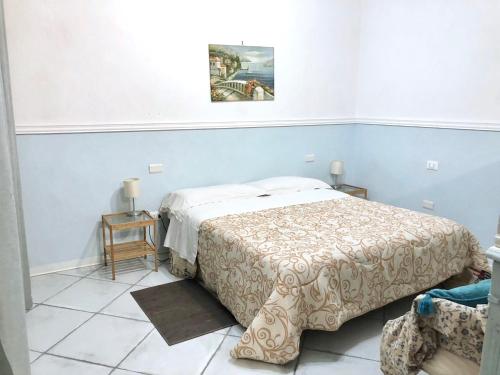 a bedroom with a bed in a blue room at TAVERNETTA SUL PORTO in Ischia
