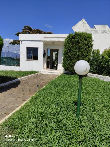 a white house with a ball in the grass at Appartamento Nausicaa in Lamezia Terme