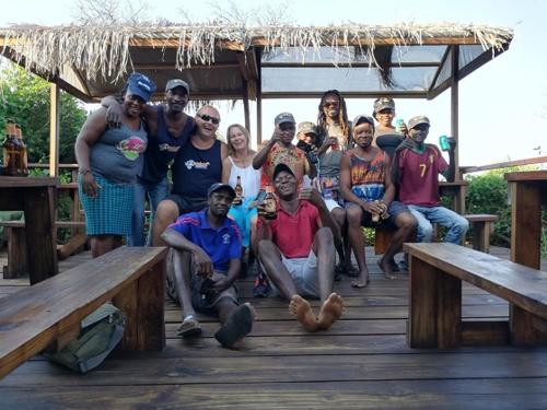 a group of people posing for a picture on a wooden deck at Underwater Explorer in Ponta do Ouro