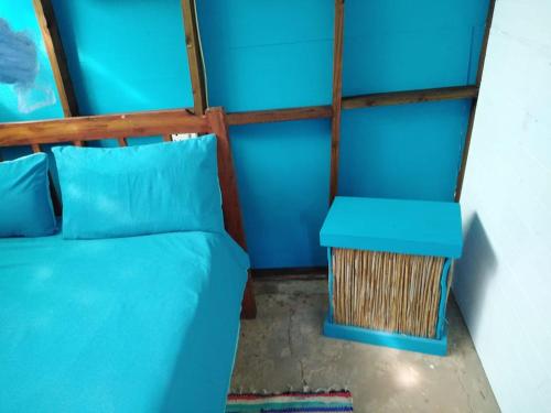 a bedroom with a blue bed and a blue table at Underwater Explorer in Ponta do Ouro