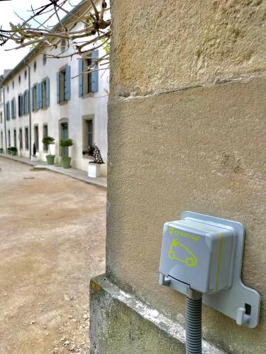 a blue box is attached to the side of a building at Logis Hôtel Château De Palaja in Carcassonne