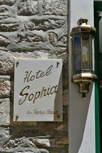 a sign on a building with a hotel scorpion sign at Hotel Sophia in Hydra