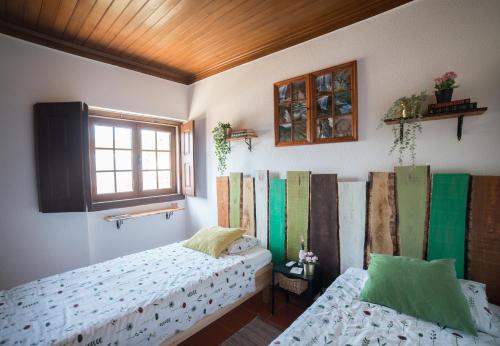 a bedroom with two beds and a window at Serra Serena in Zambujal