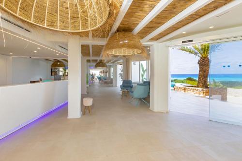 a lobby with a view of the ocean at Hotel Maysi in Playa Migjorn