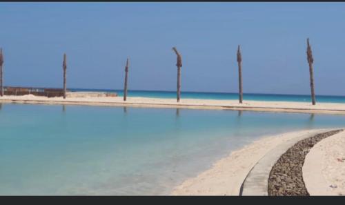 a beach with water and street lights on it at Hacienda bay painthouse 4 bathrooms in El Alamein