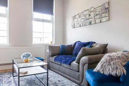 a living room with a couch and a table at West Kensington in London