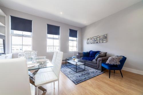 a living room with a couch and a table at West Kensington in London