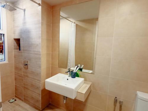 a bathroom with a sink and a shower at Windmill Upon Hills by Homespire in Genting Highlands