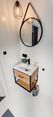 a bathroom with a sink and a mirror at Central Apartments Ogarna 4 in Gdańsk
