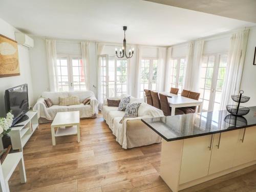 a living room with a couch and a table at Clarimar Beach Apartment by Hello Homes Sitges in Sitges