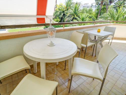 a white table and chairs in a room with a window at Clarimar Beach Apartment by Hello Homes Sitges in Sitges