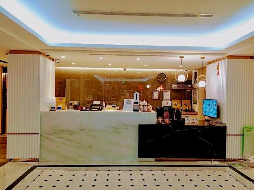 a store front with a counter in a room at Benz Hotel in Zhongli