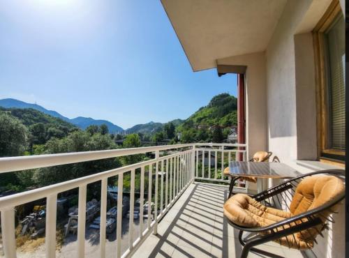a balcony with two chairs and a table with a view at Nera-etwa Konjic 2 room in Konjic