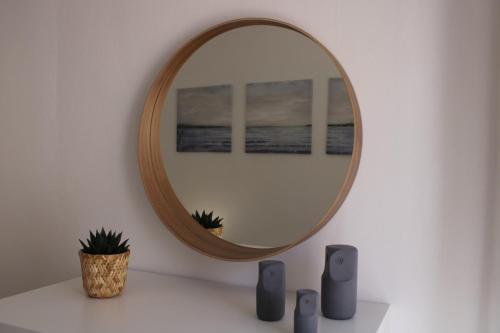 a mirror on a wall with two speakers and a plant at Casa Pisa Flores - Praia da Nazaré in Nazaré