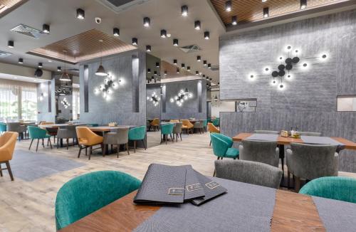 une salle à manger avec des tables, des chaises et une table dans l'établissement Hotel complex Jitomir, à Montana