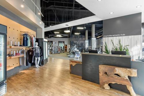 a clothing store with a bench in the middle of a room at Omni Charlotte Hotel in Charlotte