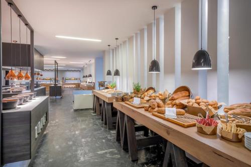 a bakery with a long line of tables with bread at Sol Marina Beach Crete in Gouves