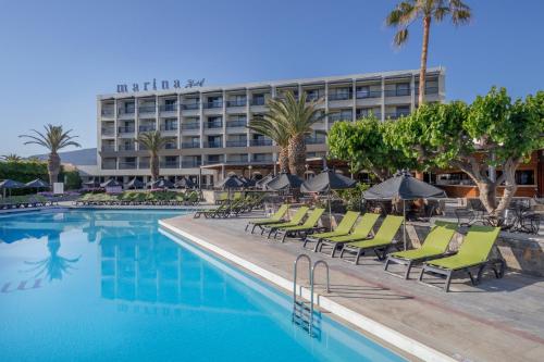 a hotel swimming pool with chairs and a hotel at Sol Marina Beach Crete in Gouves