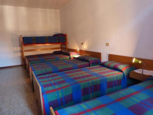 Postel nebo postele na pokoji v ubytování Ostello Al Deserto