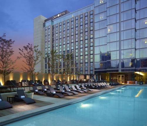 a hotel swimming pool with lounge chairs and a hotel at Omni Nashville Hotel in Nashville
