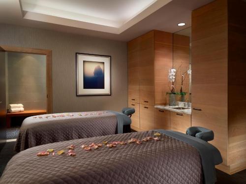a hotel room with two beds with flowers on them at Omni Nashville Hotel in Nashville