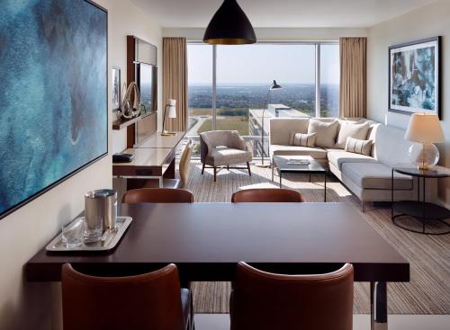 a living room with a couch and a table at Omni Frisco at The Star in Frisco