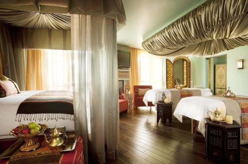 a hotel room with two beds and a living room at Omni Scottsdale Resort & Spa at Montelucia in Scottsdale