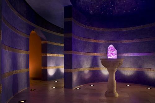 a room with a purple wall with a candle at Omni Scottsdale Resort & Spa at Montelucia in Scottsdale