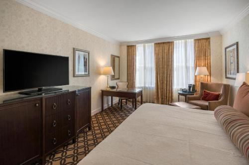 a hotel room with a bed and a flat screen tv at Omni San Francisco in San Francisco
