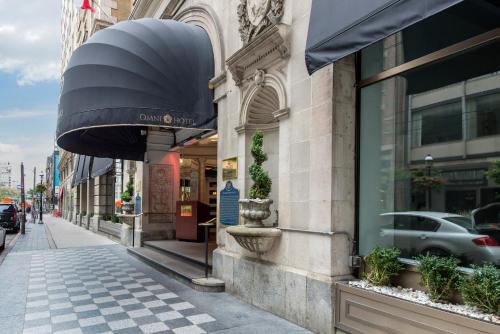 a building with an awning on a city street at The Omni King Edward Hotel in Toronto