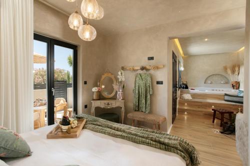 a bedroom with a bed and a living room at Archetypo Villas and Suites in Naxos Chora