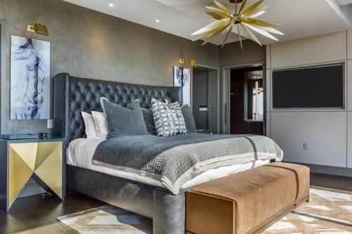 a bedroom with a large bed and a flat screen tv at Omni Louisville Hotel in Louisville