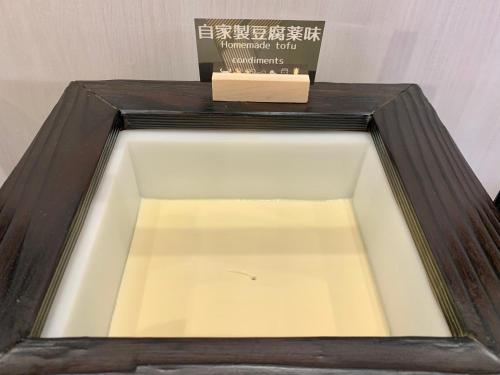 a wooden box with a book on top of it at Daiwa Roynet Hotel Sapporo Nakajima Koen in Sapporo