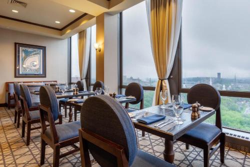 a restaurant with tables and chairs and a large window at Omni New Haven Hotel at Yale in New Haven