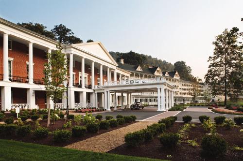 a building with a courtyard with bushes and trees at Omni Bedford Springs Resort & Spa in Bedford