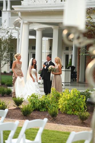 a bride and groom are standing in front of a building at Omni Bedford Springs Resort & Spa in Bedford