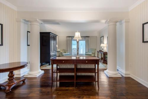 a living room with columns and a desk at Omni Bedford Springs Resort & Spa in Bedford